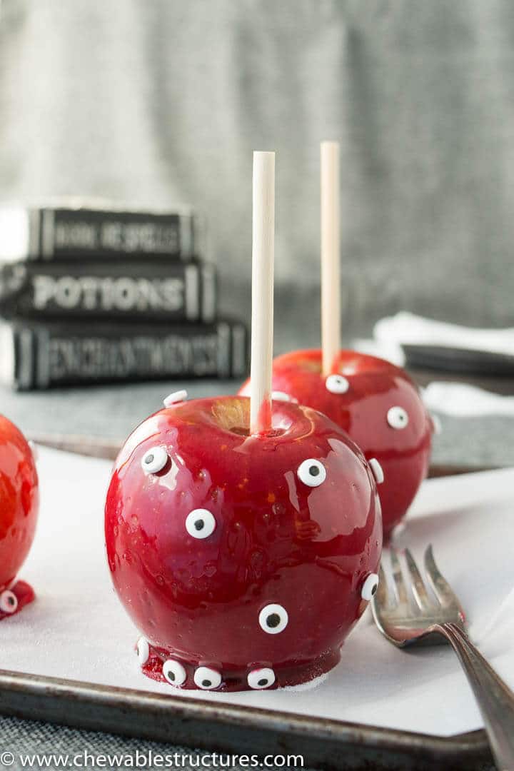A candy apple covered with candy eyeballs.