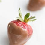 Strawberries drying on a baking sheet lined with paper towel
